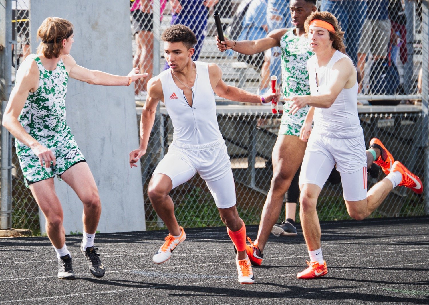 Brady Shrum, right, passes the baton to Jaxon Holland for the second leg of Mineola's 4x400 meter relay, which they won to punch their ticket to state. [view more valiant efforts]